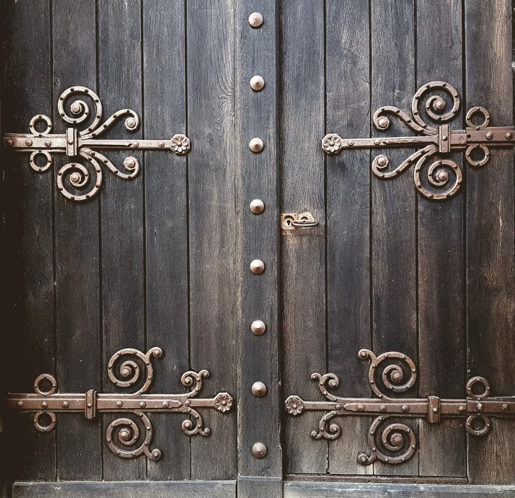 Une vieille porte en bois et ses gonds